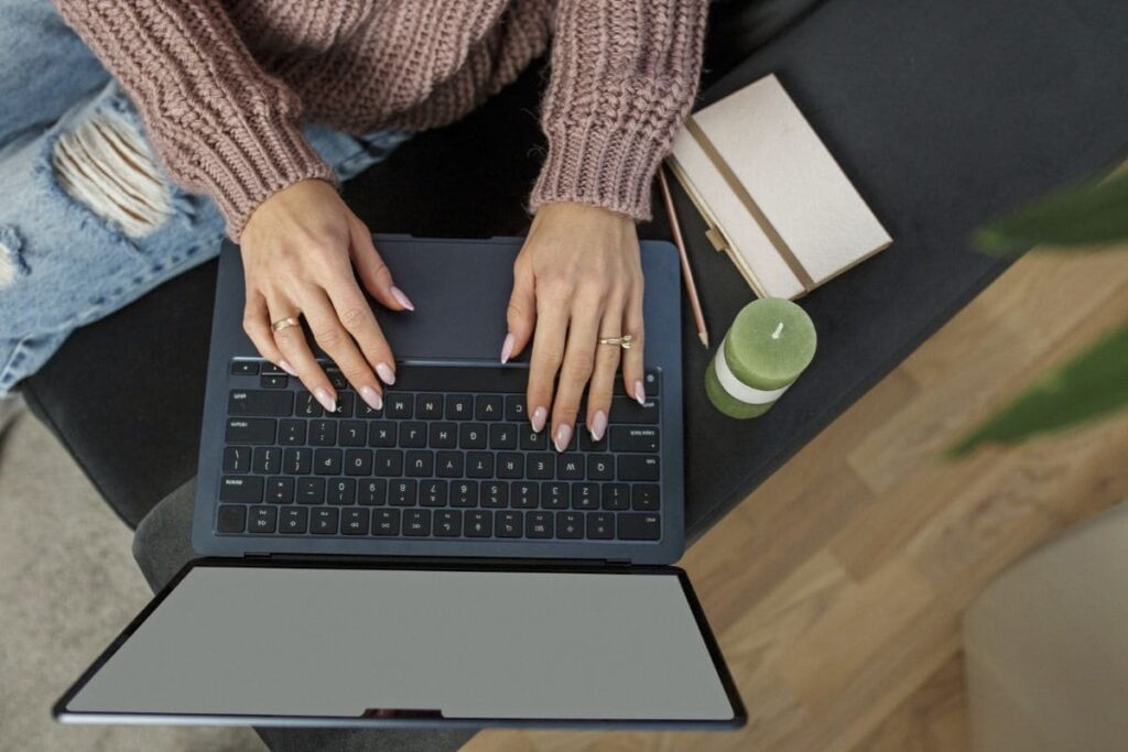 A remote worker, sitting on the floor, using a laptop.