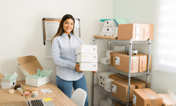 Young woman packing handmade soap to ship out to customers