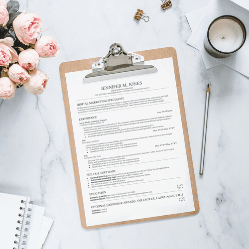 Clipboard with resume template sitting next to a vase of flowers via @theworkathomewoman