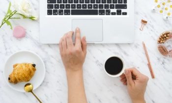 Woman reading emails on laptop computer.