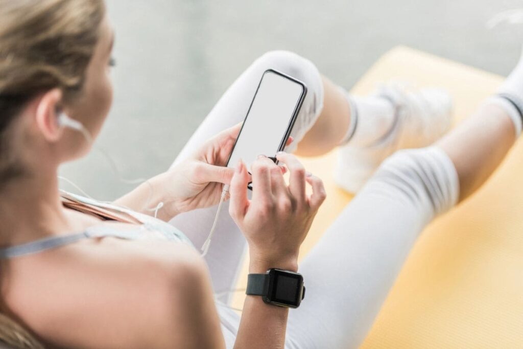 A woman exercising and using a phone.