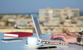 A female working on her laptop starting a travel blogging business