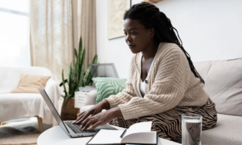 A pretty young woman with long braided hair looking for remote low-stress jobs online