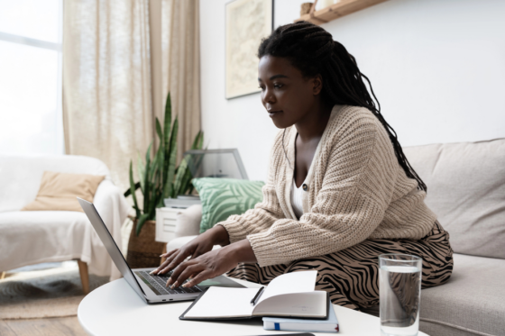 A pretty young woman with long braided hair looking for remote low-stress jobs online