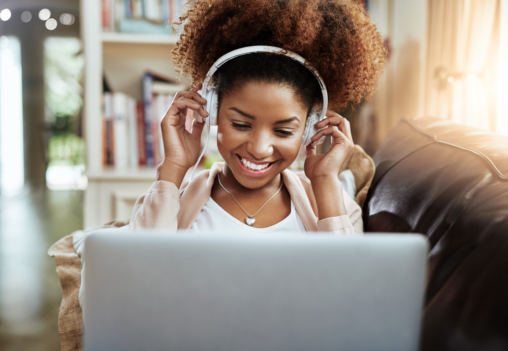 A woman who is getting paid to listen to music on her laptop