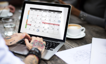 A woman working on her laptop planning out her schedule
