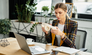 A young woman putting on headphones getting ready to write a resume