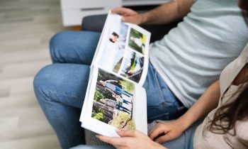 Couple looking at family photo album together.