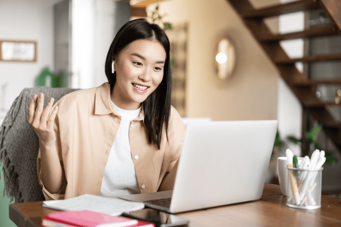 Young woman working on her laptop at home