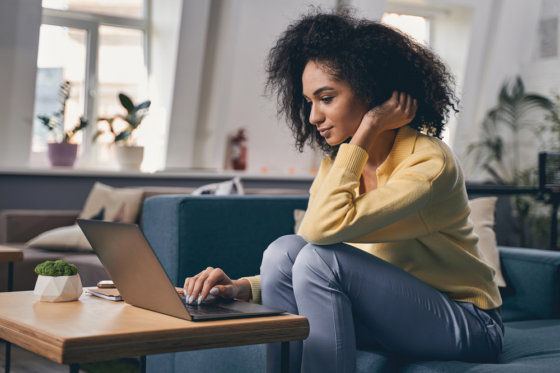 Concentrated woman staring at the laptop screen looking for legit jobs you can do from home