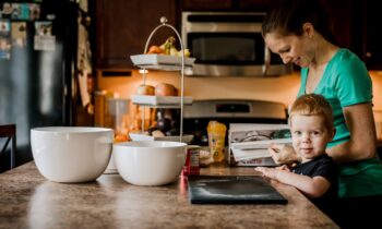 Cruise Planners Franchise Owner Kara and her son cooking in the kitchen for blog post how to become a travel agent without any experience
