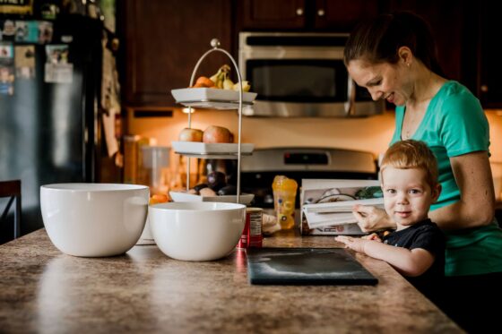 Cruise Planners Franchise Owner Kara and her son cooking in the kitchen for blog post how to become a travel agent without any experience