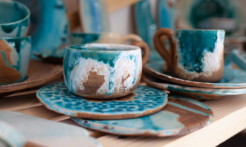 Handmade coffee mugs painted in blue and brown for blog post how to sell coffee mugs