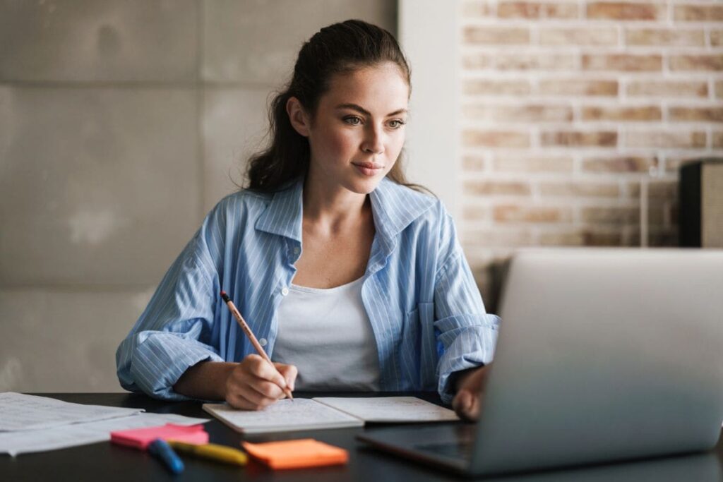 An entrepreneur working from her home office on a laptop.
