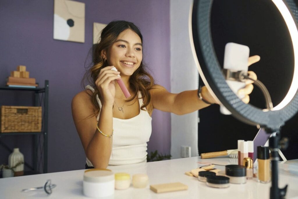 A Walmart Creator using a ring light and phone to film affiliate content.