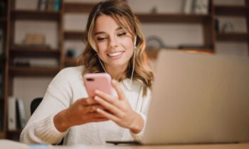 A virtual assistant working from home, using a laptop and phone for blog post create a virtual assistant portfolio