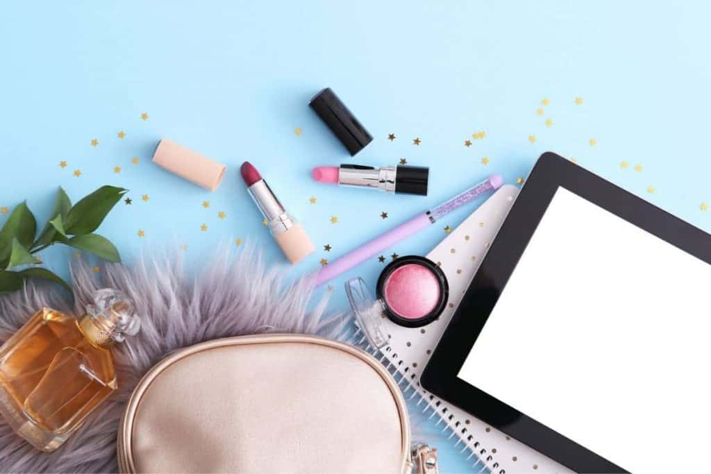 An assortment of cosmetics on the desk of a product tester