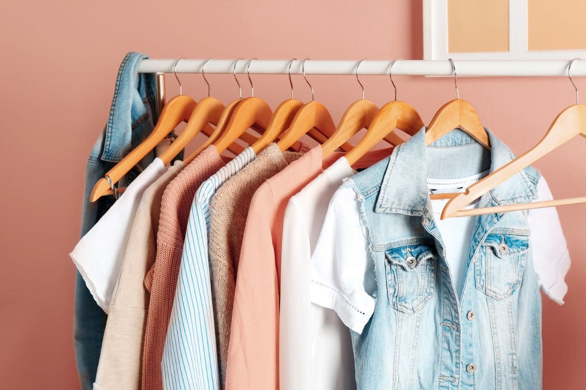 An assortment of women's clothing hanging on a clothing rack.