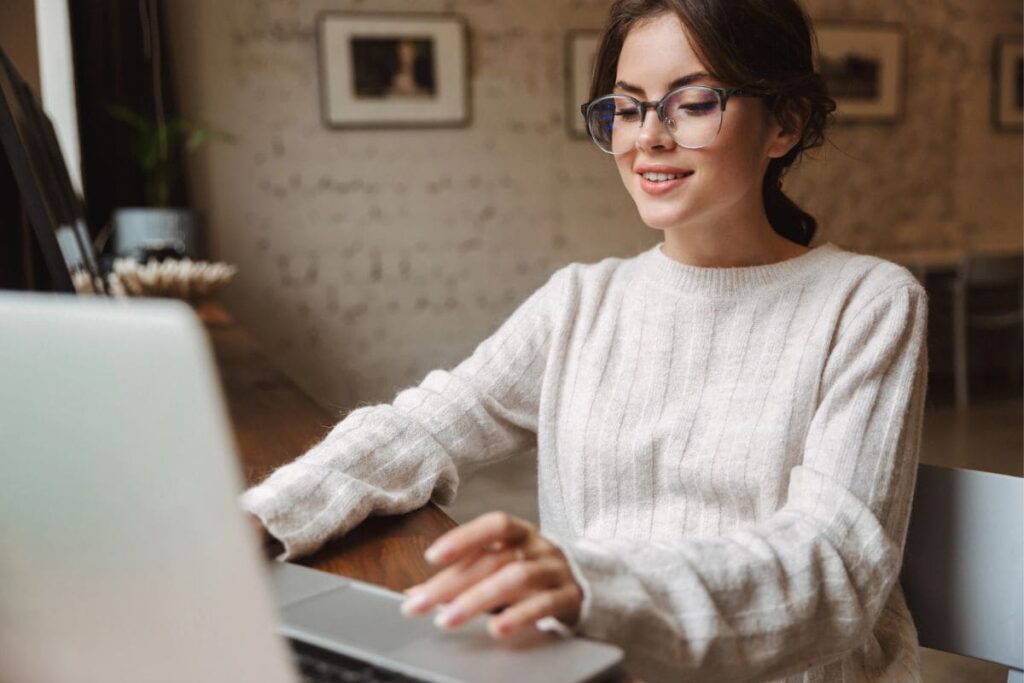 A woman working remotely in her home office, using a laptop.