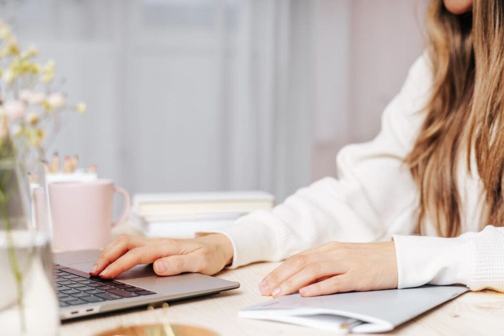 Woman working from home using laptop.