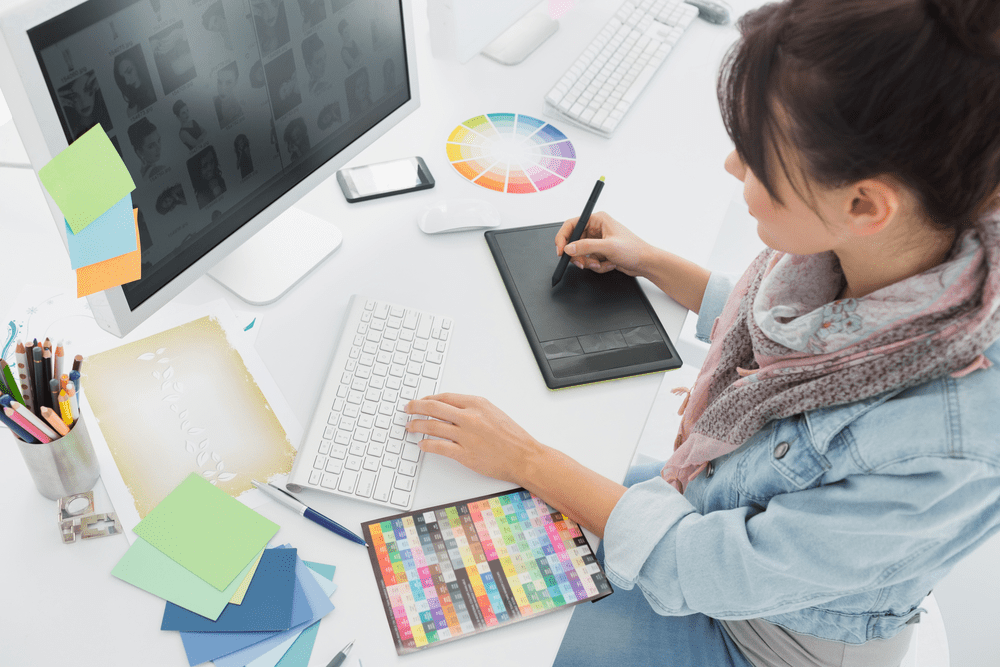 Woman working on a graphic design project in her home office