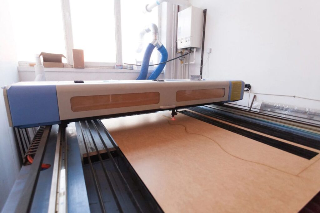 A home laser cutter setup, making a cut into wood.