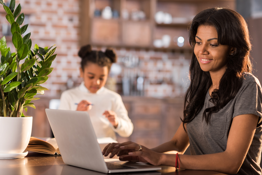 Mom working from home at kitchen table during school hours