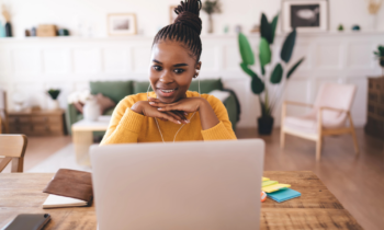 Positive African American female freelancer with chin on hands for blog post ways to make money with amazon