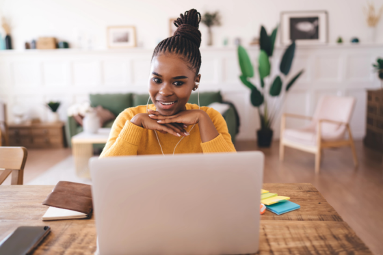Positive African American female freelancer with chin on hands for blog post ways to make money with amazon