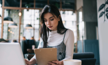Serious female remote worker in casual outfit looking for ways to make money testing websites