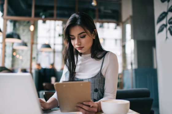 Serious female remote worker in casual outfit looking for ways to make money testing websites