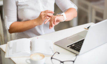 Woman looking at her watch getting ready to start her early morning job