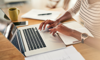 woman looking for a legit work from home job on her laptop for post avoid work from home scams