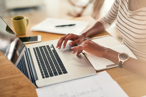 woman looking for a legit work from home job on her laptop for post avoid work from home scams