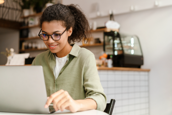 Woman on her laptop searching for online test scoring jobs