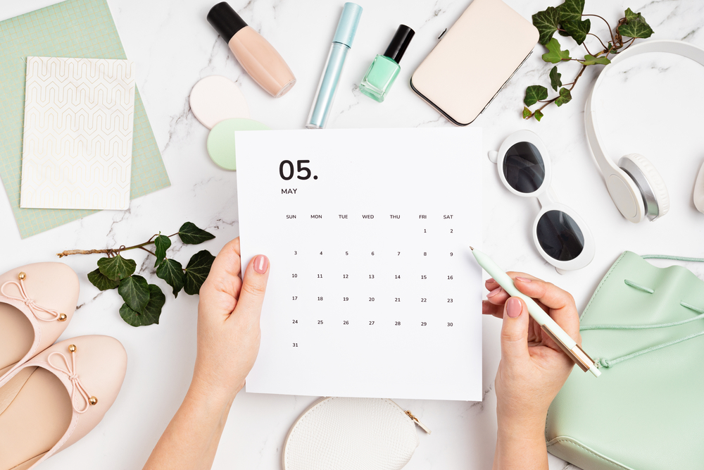 Woman using sales trends calendar to plan marketing strategy for her eBay selling business