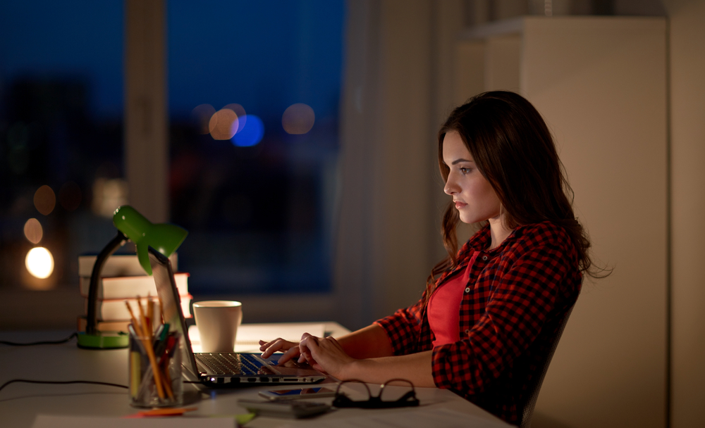 Women working in her home on laptop at night