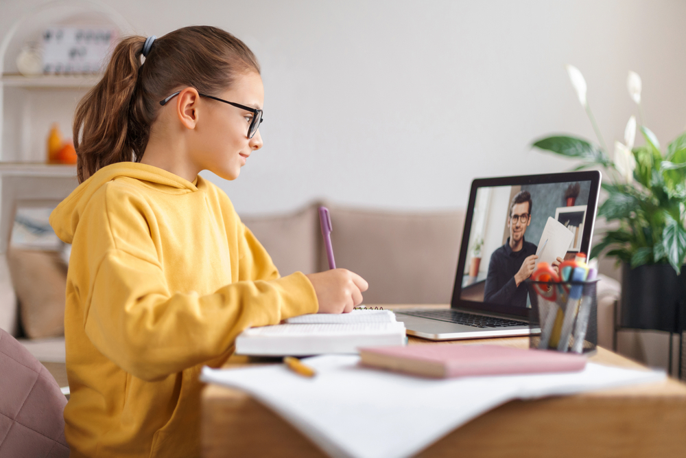 Young female student attending an online tutoring session