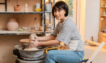 Young woman sculpting a vase on a pottery wheel for blog post fun ways to make money