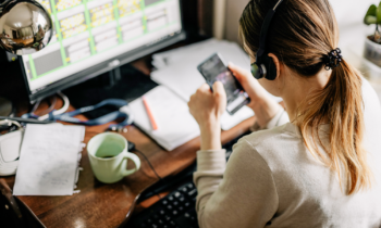 Young woman sitting at desk taking calls for her new work from home no experience job