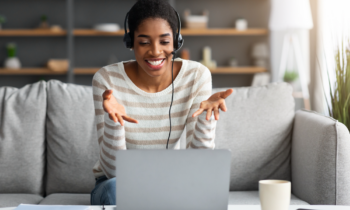 Young woman wearing a headset taking calls for her remote customer service job