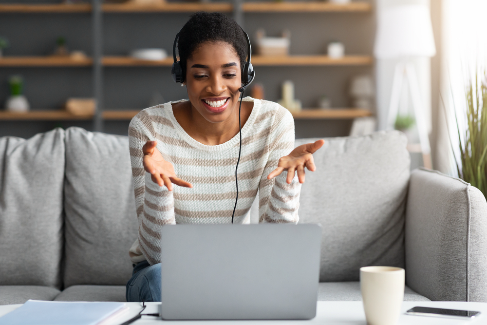 Young woman wearing a headset taking calls for her remote customer service job