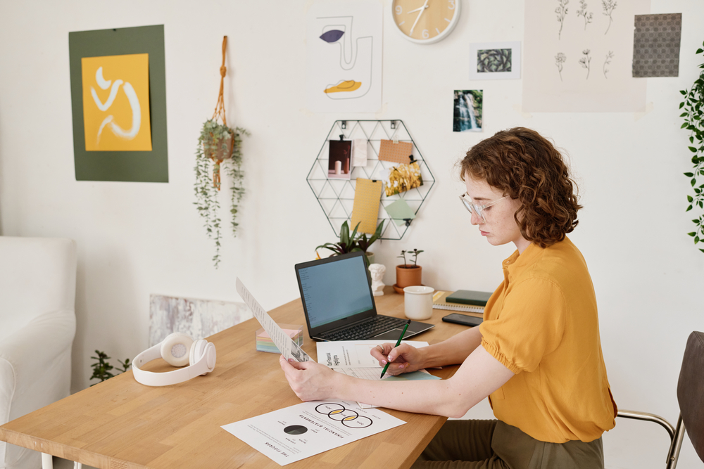 Young woman working from home reviewing documents for Amazon