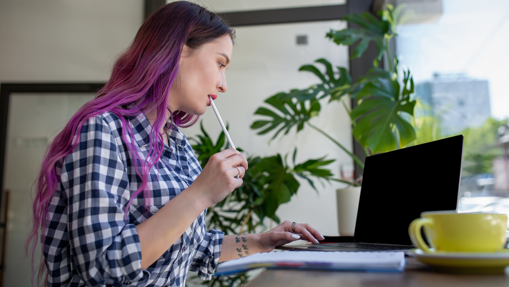 college student working online to make money has long purple hair - for blog post online jobs for college students