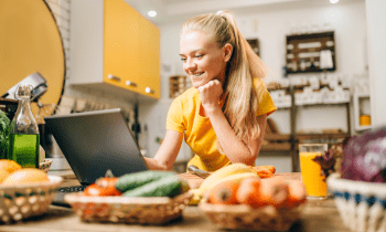 young woman in the kitchen cooking healthy meals for her blog