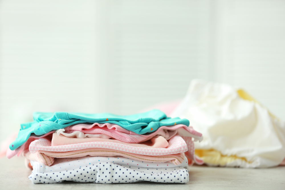 pile of baby clothes to be sold on thredUP